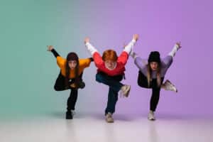 Three young people are jumping in the air.
