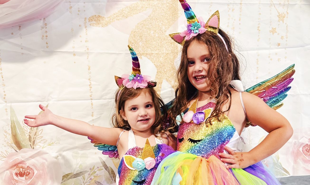 Two girls dressed as unicorns.